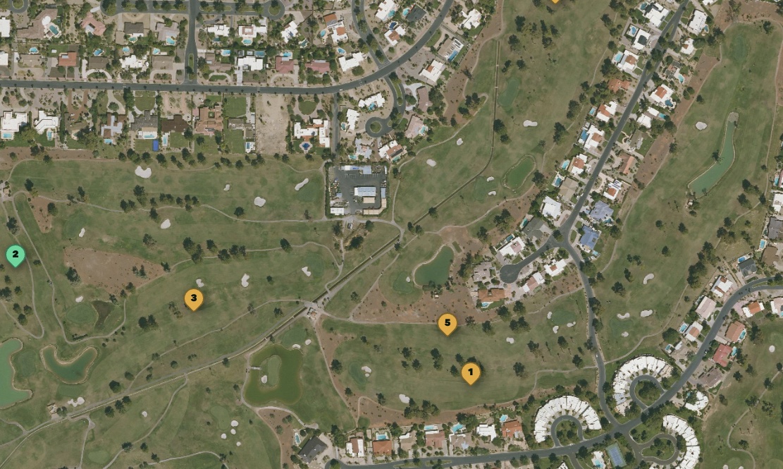 Aerial photo of a golf course with numbered pins marking waiting golfers